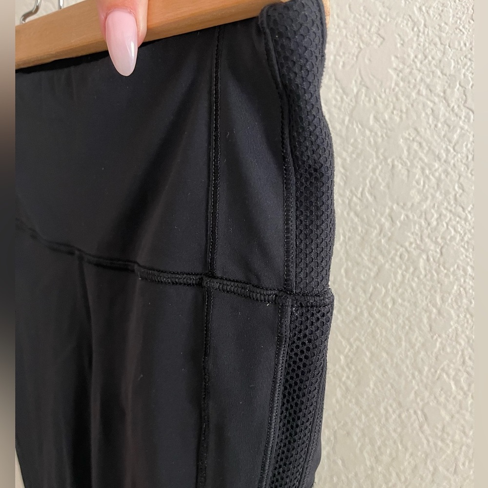 Lululemon black legging jogger look with mesh detail. Size 4. 25” inseam.